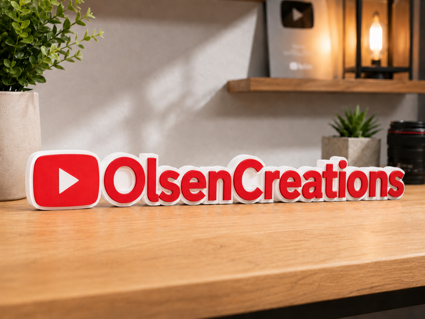 Red and white OlsenCreations sign with YouTube-style play button icon